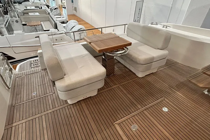  Yacht Photos Pics Luxurious seating area on 2026 Prestige F4.9 yacht with wooden deck and table.