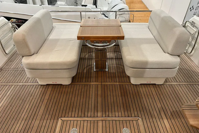  Yacht Photos Pics Luxury seating area on 2026 Prestige F4.9 yacht with wooden deck and table.