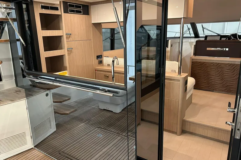  Yacht Photos Pics Modern interior of 2026 Prestige F4.9 yacht, featuring sleek wood finishes and elegant design.