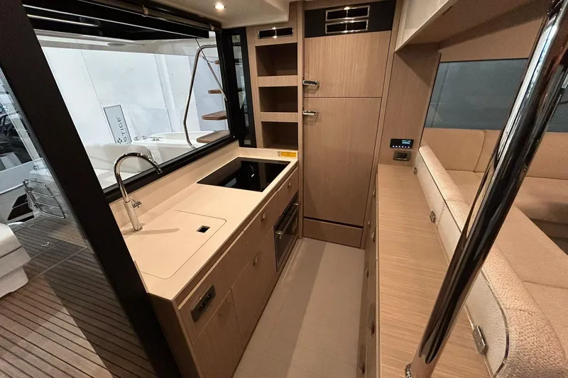  Yacht Photos Pics Modern kitchen interior of 2026 Prestige F4.9 yacht with sleek cabinetry and appliances.