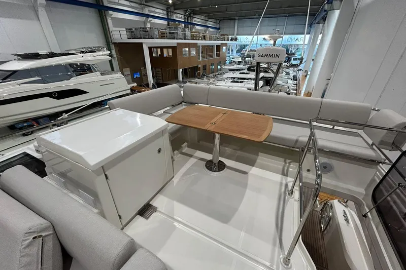  Yacht Photos Pics Luxurious Prestige F4.9 yacht interior, 2026 model, featuring elegant seating and a wooden table.