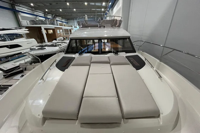  Yacht Photos Pics 2026 Prestige F4.9 yacht with spacious deck and modern design in a showroom.