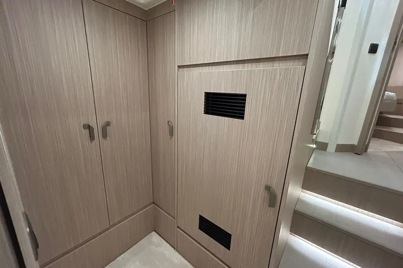  Yacht Photos Pics Modern interior of Prestige F4.9 yacht, 2026 model, featuring sleek wooden cabinetry.