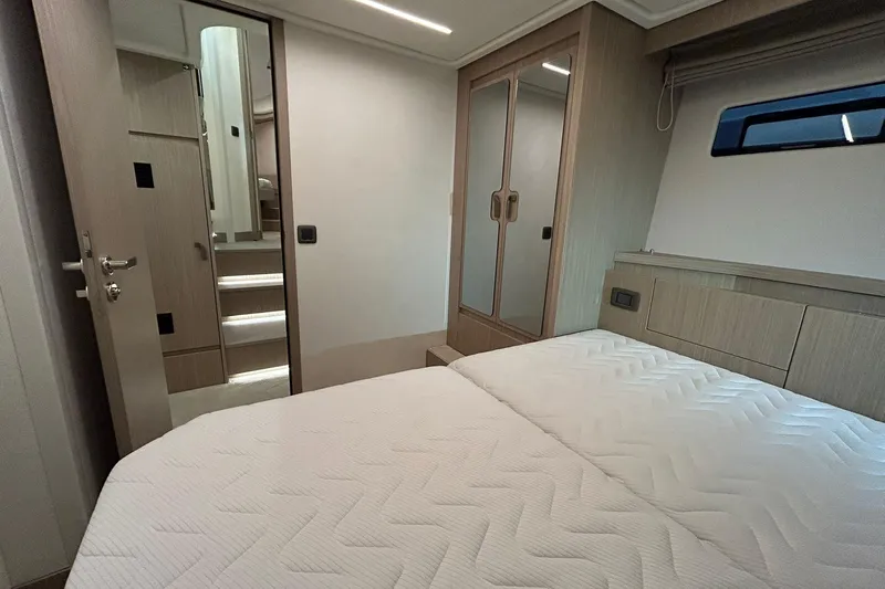  Yacht Photos Pics Luxurious bedroom interior of 2026 Prestige F4.9 yacht with modern design and elegant furnishings.
