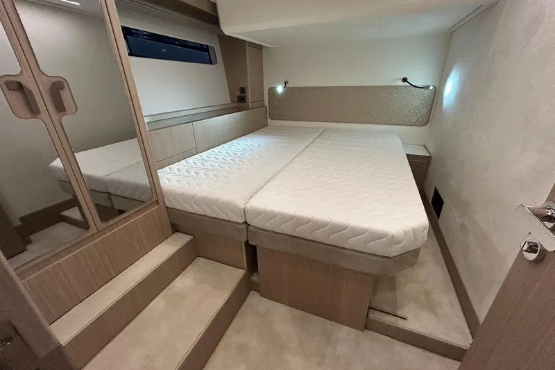  Yacht Photos Pics Luxurious cabin interior of 2026 Prestige F4.9 yacht with modern bedding and ambient lighting.