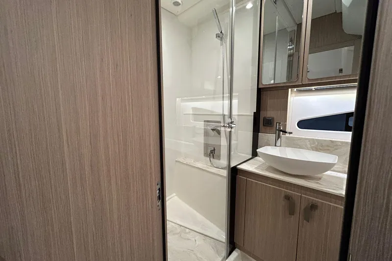  Yacht Photos Pics Modern bathroom in 2026 Prestige F4.9 yacht with sleek shower and elegant sink design.