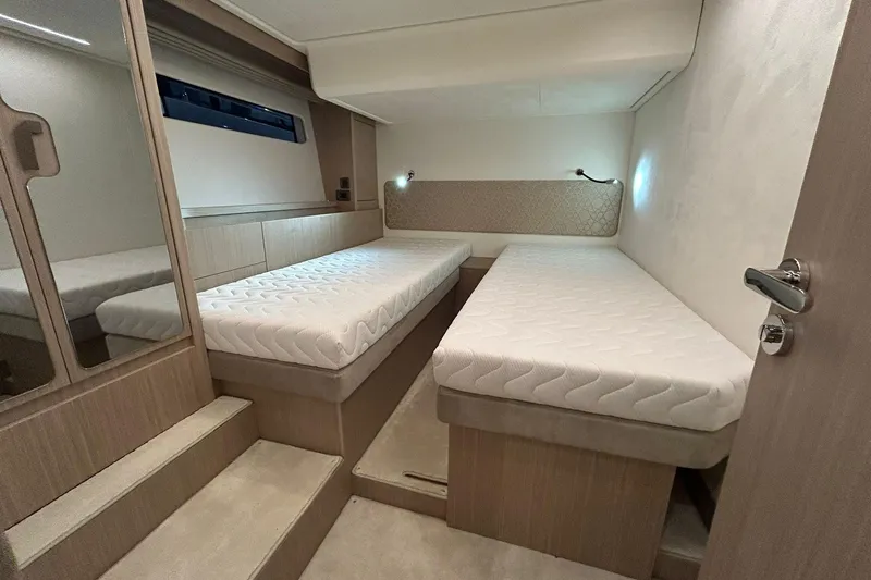  Yacht Photos Pics Modern twin cabin interior in 2026 Prestige F4.9 yacht, featuring sleek design and comfortable bedding.