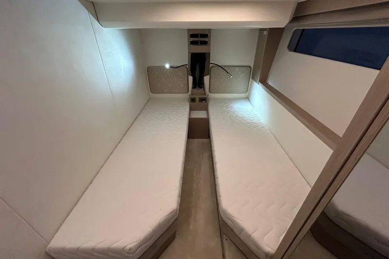  Yacht Photos Pics Twin beds in a 2026 Prestige F4.9 yacht cabin, featuring modern design and ambient lighting.