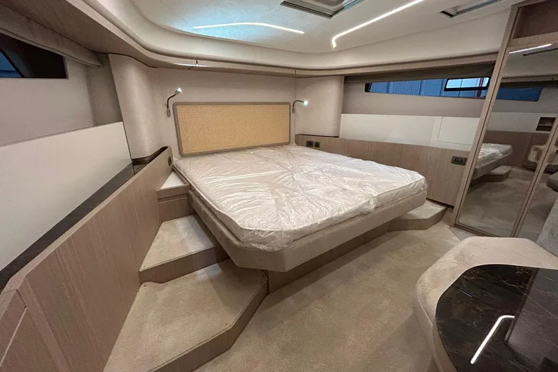  Yacht Photos Pics Luxurious bedroom interior of 2026 Prestige F4.9 yacht with modern design and ambient lighting.