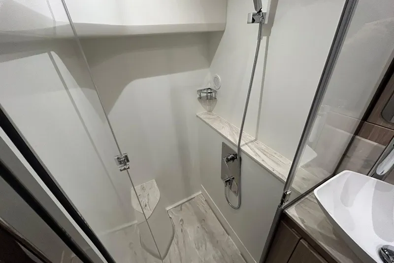  Yacht Photos Pics Modern shower interior in 2026 Prestige F4.9, featuring sleek design and glass door.