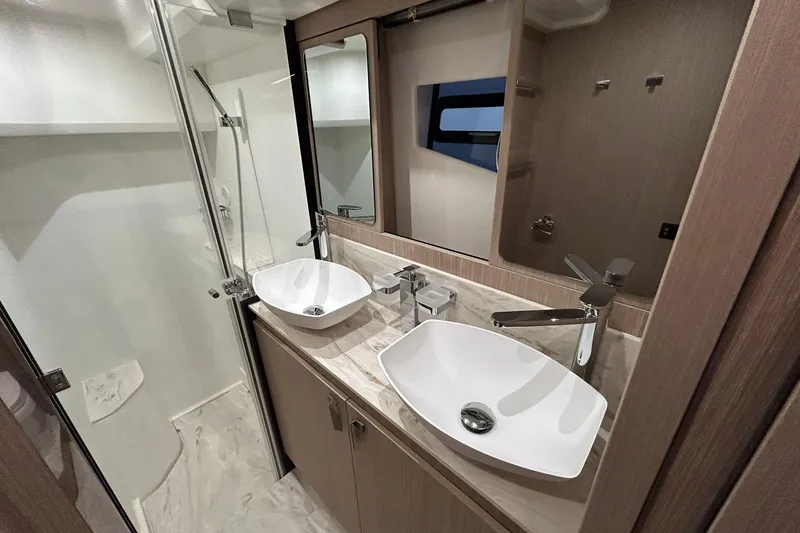  Yacht Photos Pics Luxurious bathroom in 2026 Prestige F4.9 yacht with dual sinks and modern fixtures.