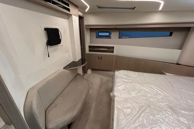  Yacht Photos Pics 2026 Prestige F4.9 interior with modern design, featuring a cozy seating area and bed.