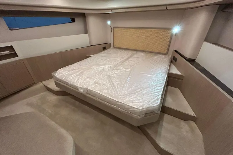  Yacht Photos Pics Luxurious bedroom interior of 2026 Prestige F4.9 yacht with modern design and ambient lighting.