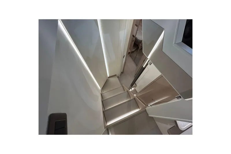  Yacht Photos Pics Modern yacht interior staircase with sleek design, featuring ambient lighting. Prestige F4.9, 2026 model.