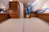 Luxurious interior of 2022 Nimbus T11 yacht with wooden finishes and ambient lighting.