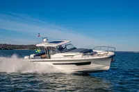 2022 Nimbus T11 boat cruising on open water under clear blue skies.