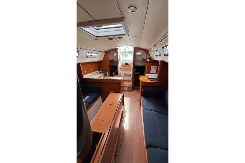 Tarahumara Yacht Photos Pics Interior of 2008 J Boats J/122 sailboat with wood finish and seating area.