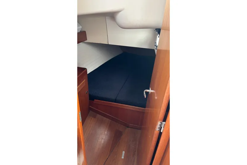 Tarahumara Yacht Photos Pics 2008 J Boats J/122 cabin interior with wooden finish and cozy sleeping area.