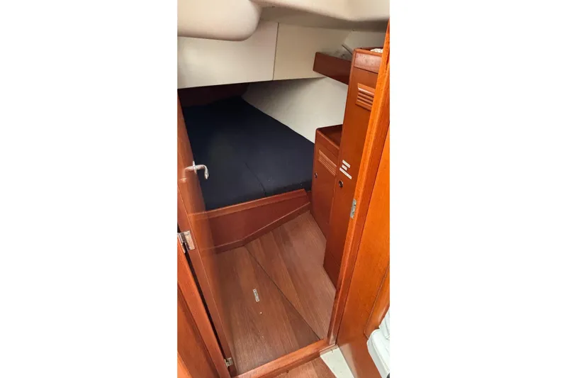 Tarahumara Yacht Photos Pics Interior cabin of 2008 J Boats J/122, featuring wooden finish and cozy sleeping area.