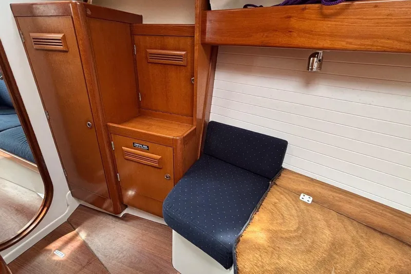 Tarahumara Yacht Photos Pics Interior of 2008 J Boats J/122 sailboat with wooden cabinetry and blue seating.