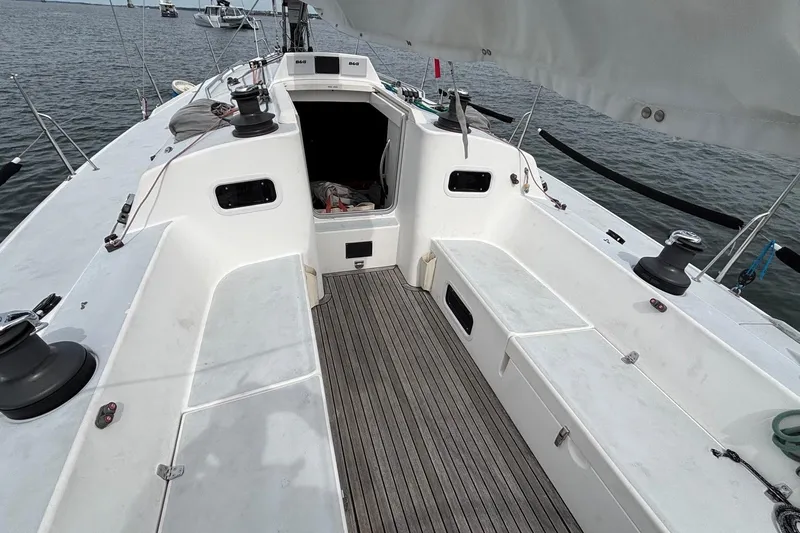 Tarahumara Yacht Photos Pics 2008 J Boats J/122 sailboat cockpit with teak flooring and winches, docked on calm water.