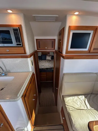 Lola Yacht Photos Pics Interior of 2005 Cabo 35 Flybridge with kitchen and seating area.