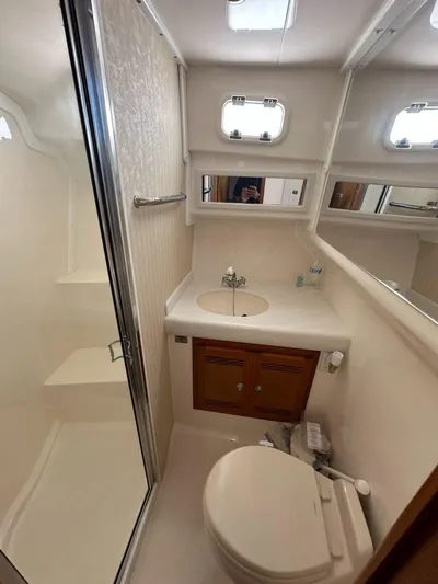 Lola Yacht Photos Pics Bathroom in 2005 Cabo 35 Flybridge boat with shower and toilet.