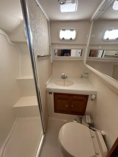 Lola Yacht Photos Pics Bathroom of 2005 Cabo 35 Flybridge with shower and sink.