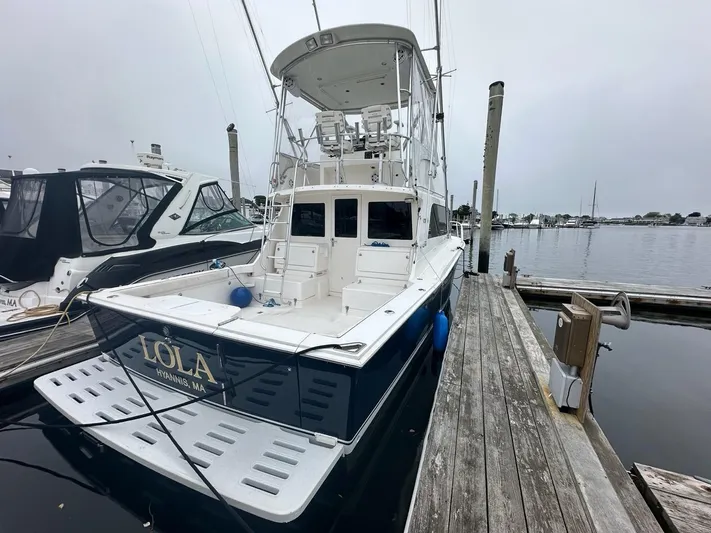 Lola Yacht Photos Pics 2005 Cabo 35 Flybridge boat docked at marina.