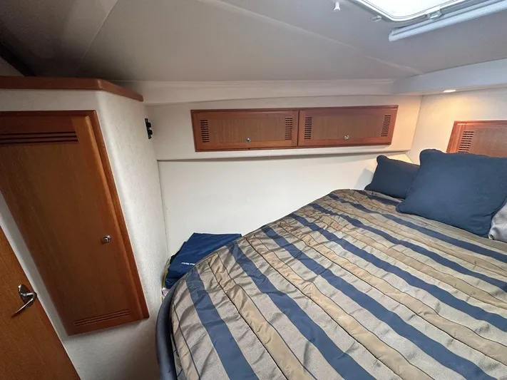 Lola Yacht Photos Pics Interior of 2005 Cabo 35 Flybridge with bed and cabinets.