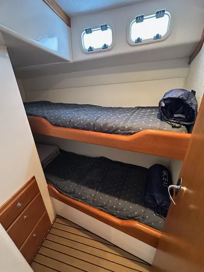 Lola Yacht Photos Pics Interior of 2005 Cabo 35 Flybridge with bunk beds.
