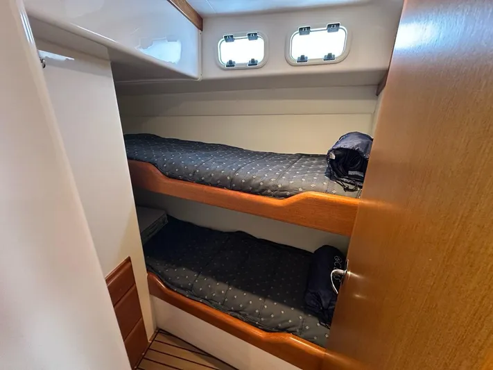 Lola Yacht Photos Pics Interior of 2005 Cabo 35 Flybridge with bunk beds.
