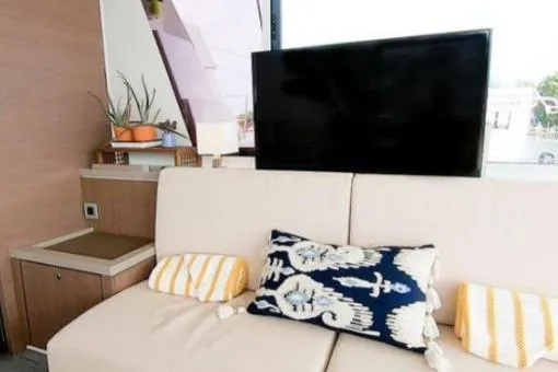 Joy Yacht Photos Pics Modern yacht interior with cozy sofa, decorative pillows, and a flat-screen TV. Bali 5.4, 2021 model.
