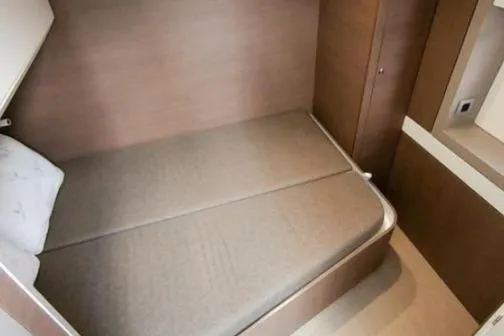 Joy Yacht Photos Pics Compact cabin interior of 2021 Bali 5.4 yacht with cozy bed and wooden finish.