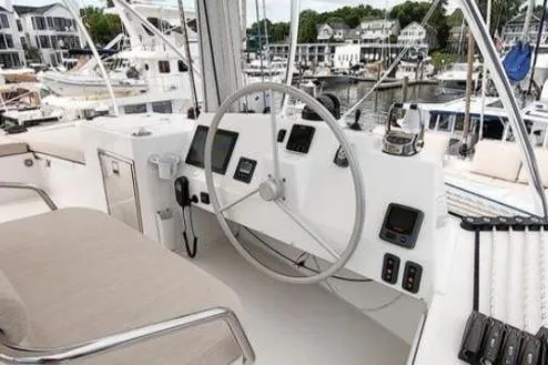 Joy Yacht Photos Pics Helm of 2021 Bali 5.4 yacht with modern navigation equipment in a marina setting.