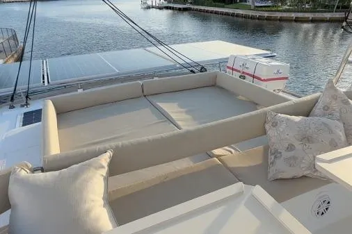 Joy Yacht Photos Pics Luxurious 2021 Bali 5.4 yacht with spacious deck seating and scenic waterfront view.