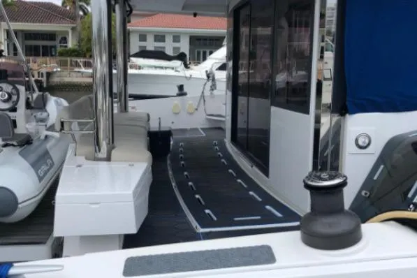 Joy Yacht Photos Pics Catamaran deck view, Bali 5.4 model, 2021, docked at marina with inflatable boat.