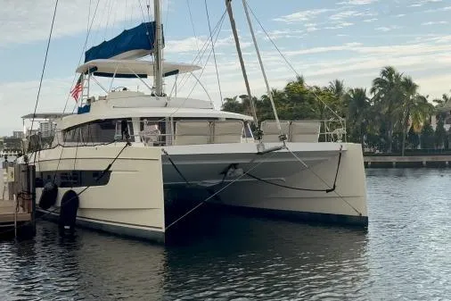Joy Yacht Photos Pics 2021 Bali 5.4 catamaran docked in a serene marina setting.