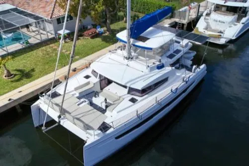 Joy Yacht Photos Pics 2021 Bali 5.4 catamaran docked, featuring spacious deck and modern design.
