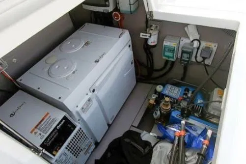 Joy Yacht Photos Pics Engine compartment of a 2021 Bali 5.4 model, featuring electrical components and storage.