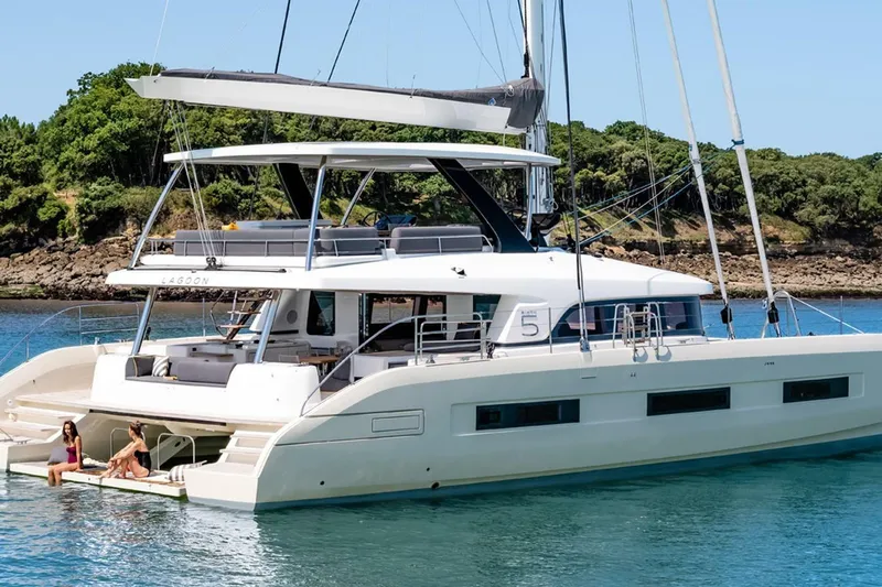 Olivia 007 Yacht Photos Pics 2025 Lagoon 65 yacht on serene water, featuring spacious deck and modern design.