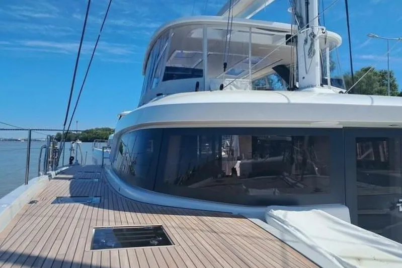 Olivia 007 Yacht Photos Pics 2025 Lagoon 65 yacht with sleek design, spacious deck, and modern features under a clear blue sky.