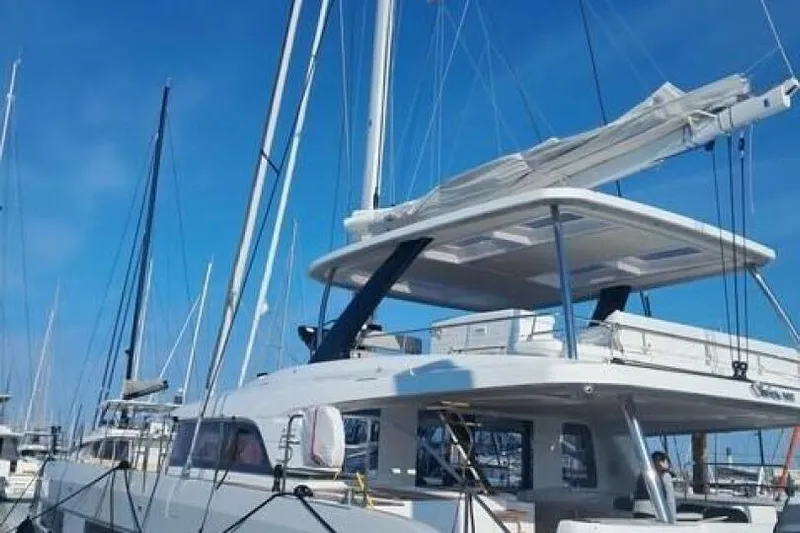 Olivia 007 Yacht Photos Pics 2025 Lagoon 65 yacht docked under clear blue sky.