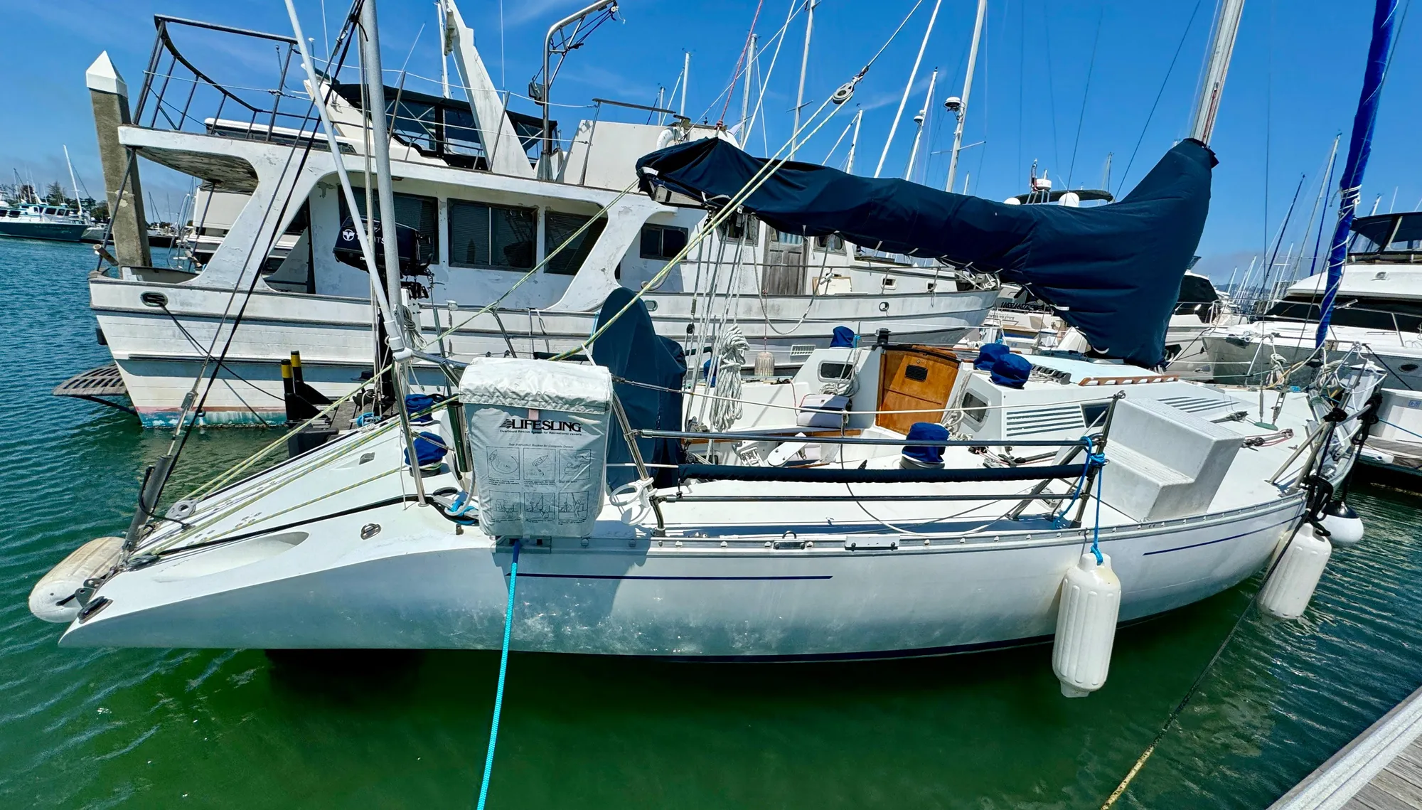 1988 Beneteau First Class 12 sailboat docked in marina, side view.