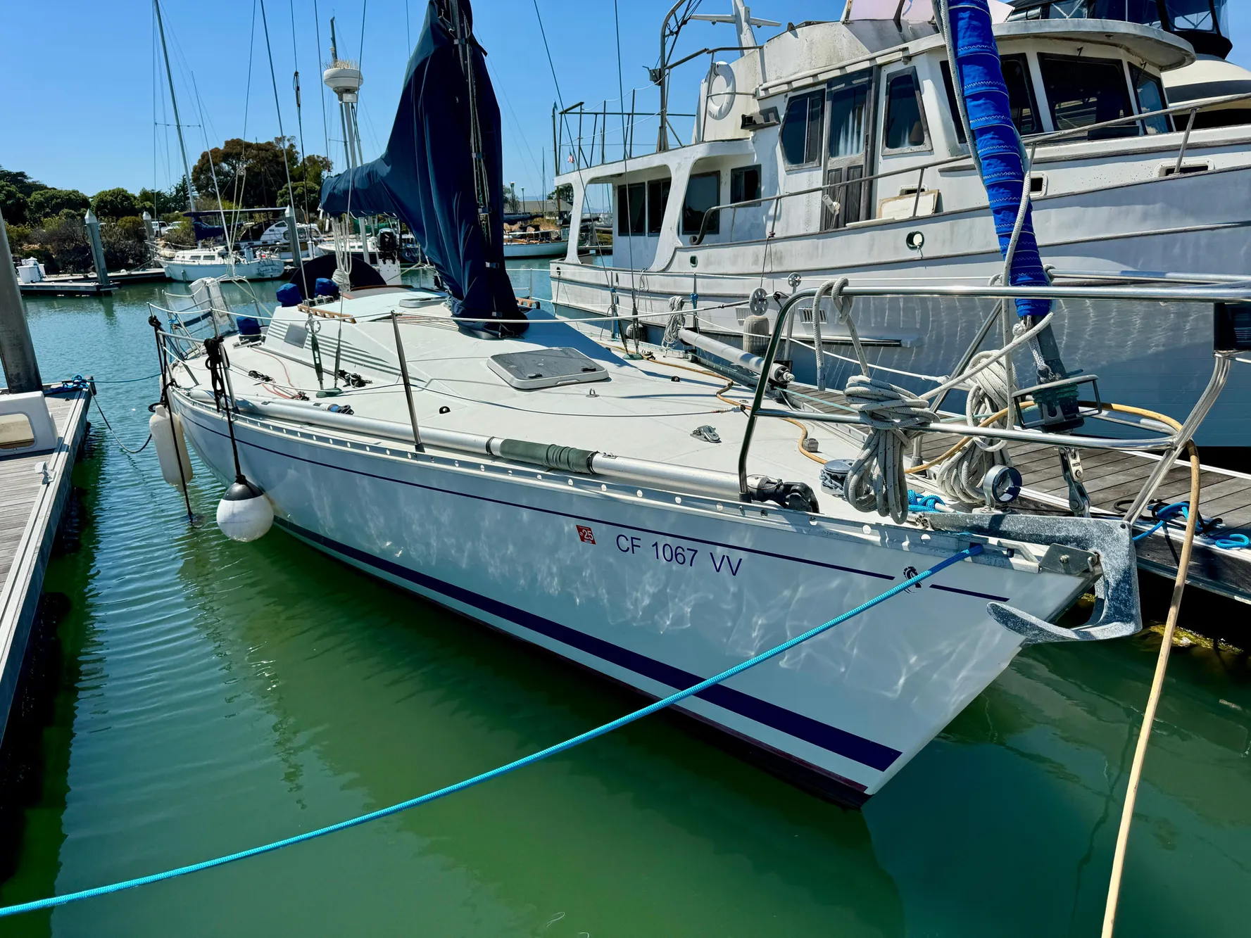 1988 Beneteau First Class 12 sailboat docked in marina, sunny day.