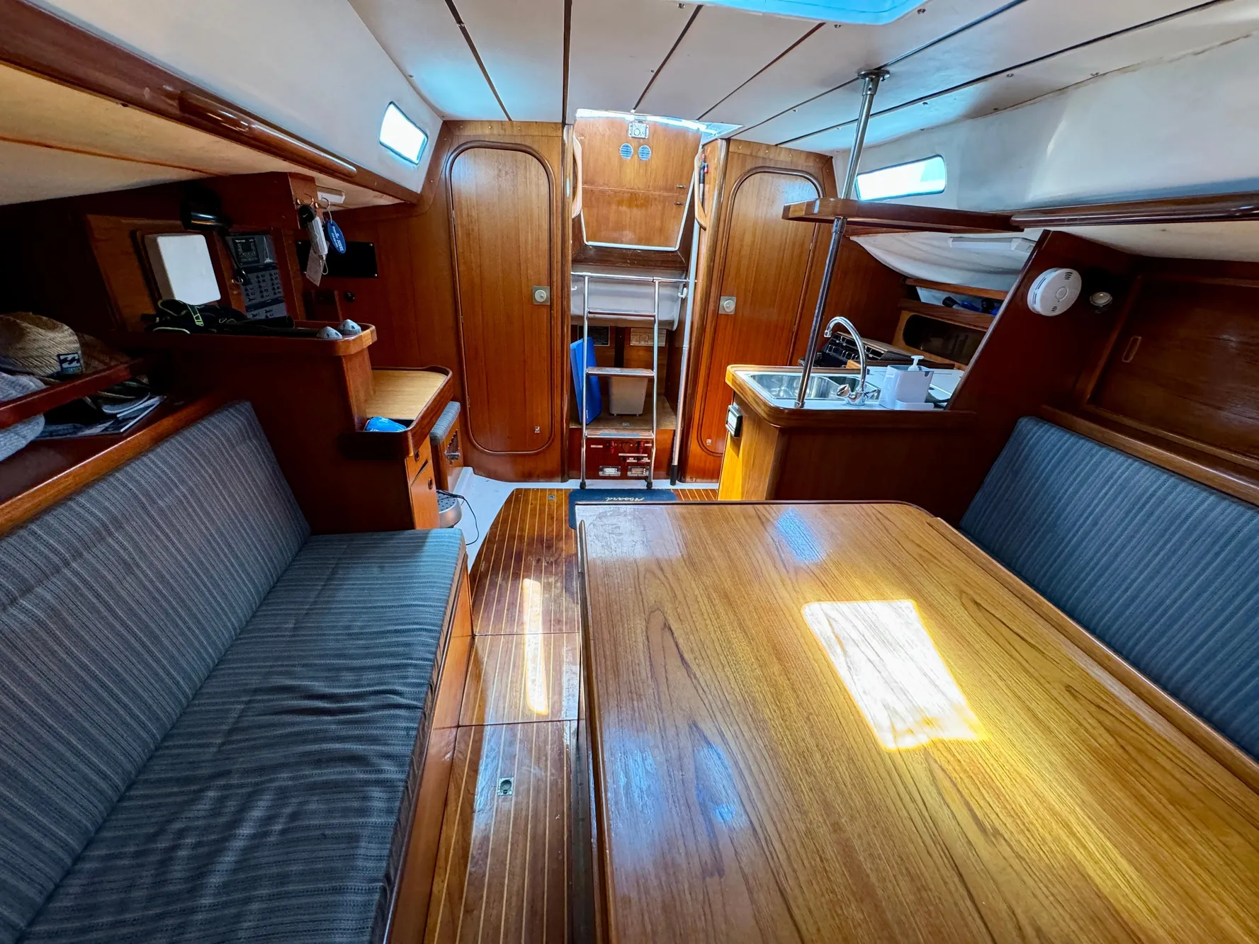 Interior of 1988 Beneteau First Class 12 sailboat with wood finish and seating area.