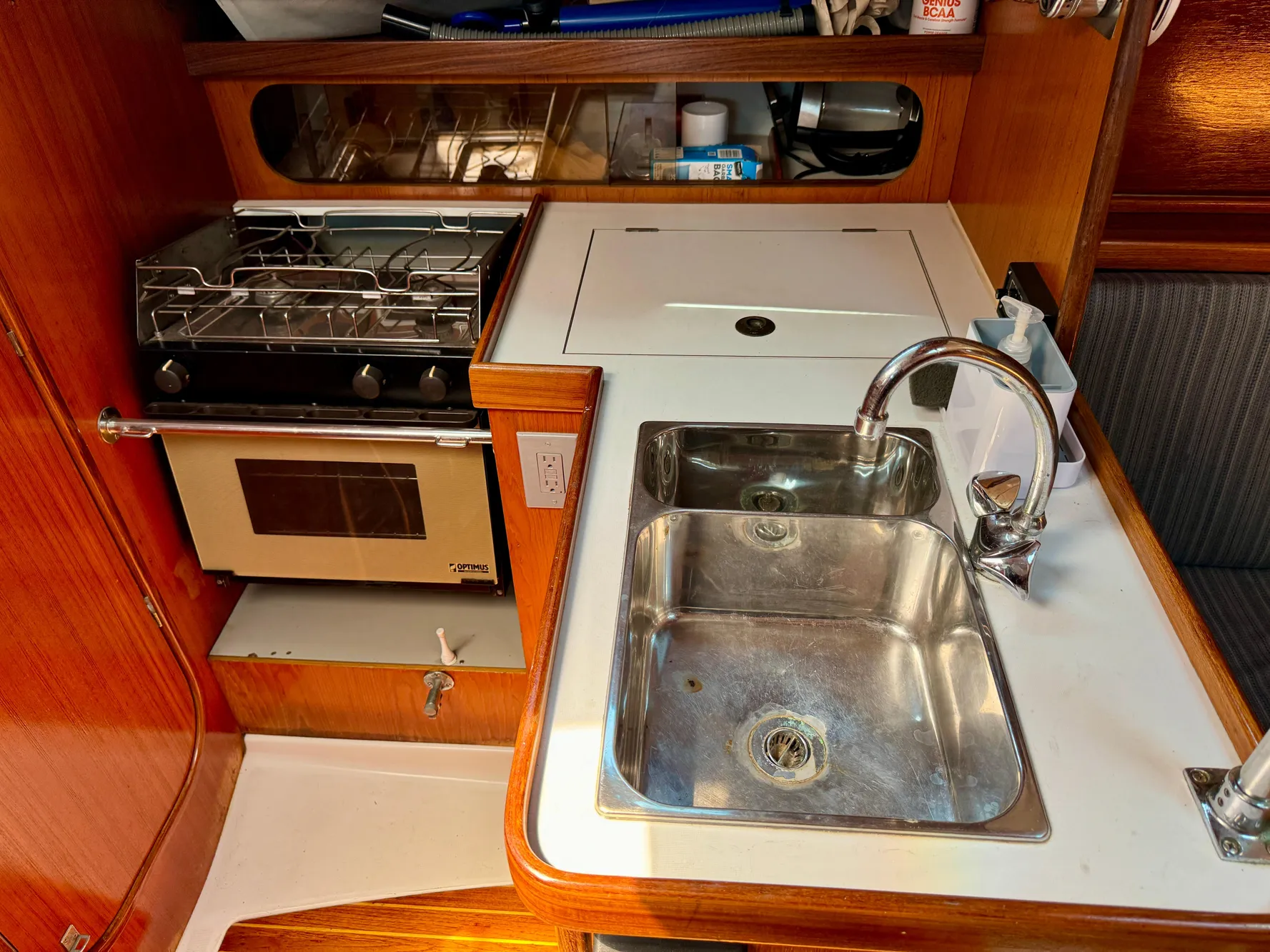 Galley kitchen in 1988 Beneteau First Class 12 yacht with stove and sink.