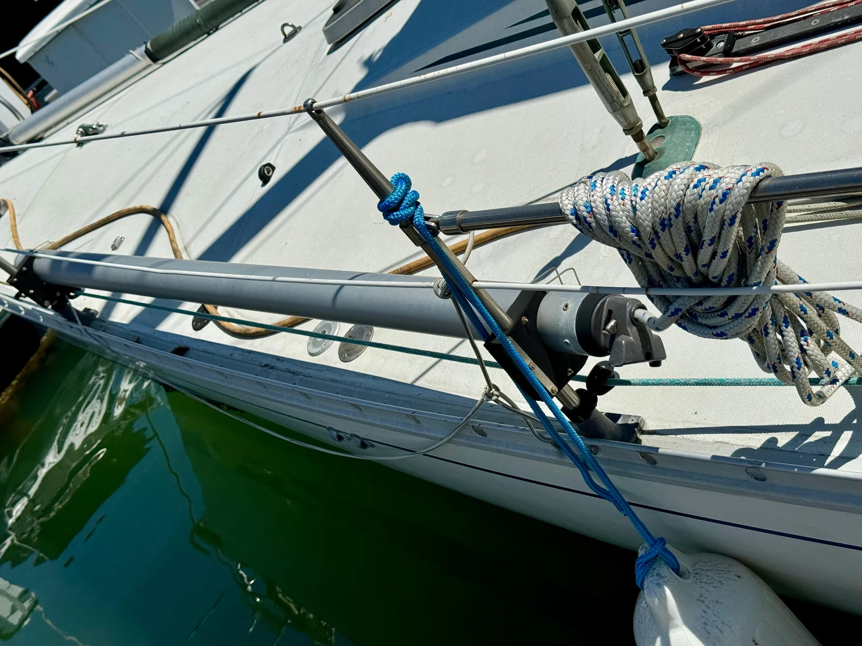 1988 Beneteau First Class 12 sailboat deck with ropes and rigging details.