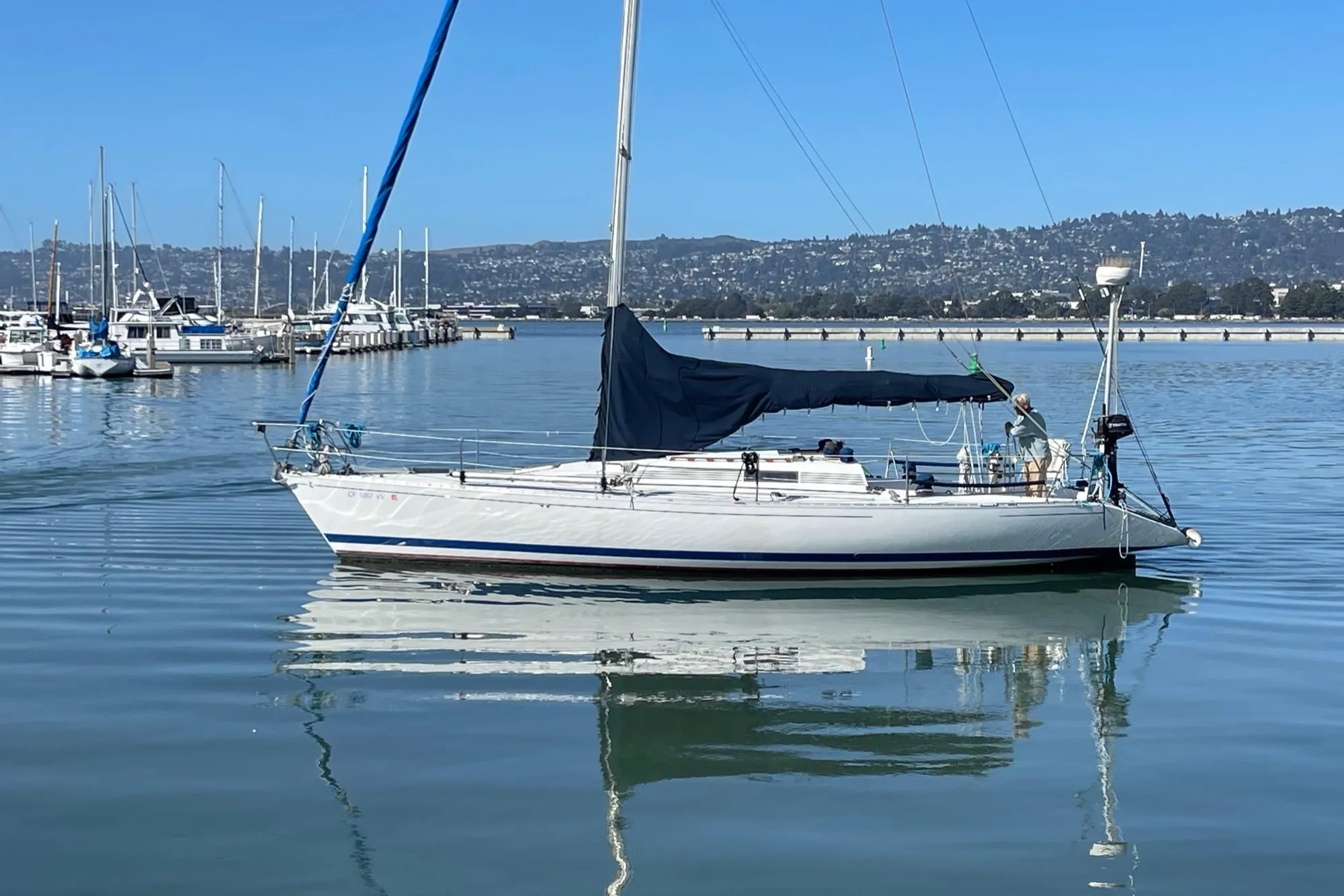 1988 Beneteau First Class 12 sailboat docked in a calm marina.