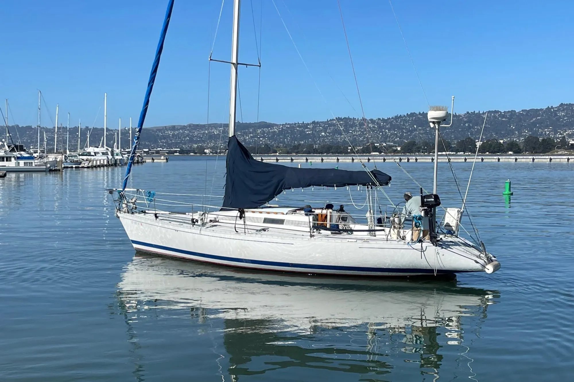 1988 Beneteau First Class 12 sailboat docked in a calm marina.
